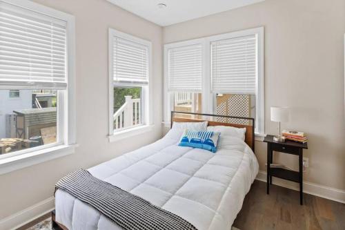 a white bedroom with a large bed and windows at Renovated Beach Block 7BR North Beach Atlantic City - Steps to Beach & Casino in Atlantic City