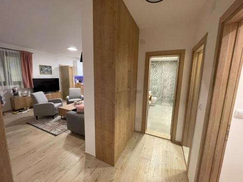 a room with a living room and a living room with a door at Casa Valley Paradiso - Jahorina in Jahorina