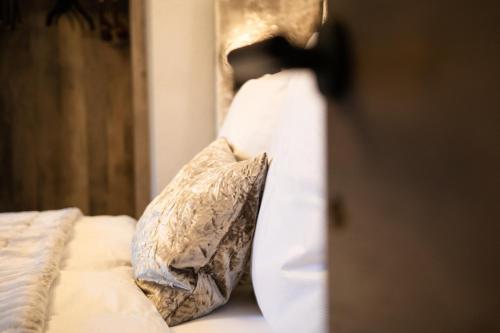 a close up of a bed with pillows on it at Luxury Apart Sailers including Premium Summercard in Sankt Anton am Arlberg