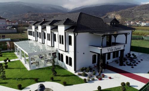 an overhead view of a white building with mountains in the background at Hotel Vila Zana in Gostivar