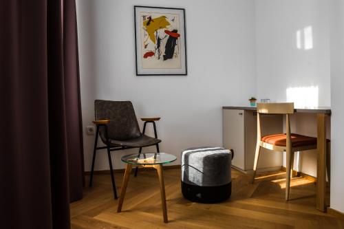 a living room with two chairs and a table at Hotel Belmur in Murska Sobota