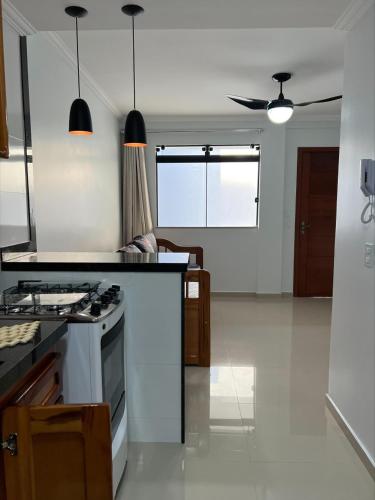 a kitchen with a stove and a counter top at Arraial do Cabo Village Pôr Do Sol in Arraial do Cabo
