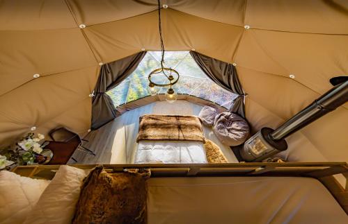 an inside of a tent with a bed in it at Luna Domes in Chiddingstone