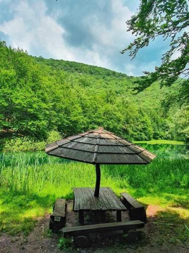 a table with an umbrella on top of it at Apartmani Grza in Paraćin