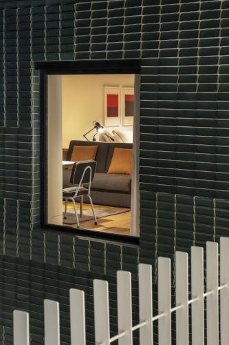a mirror on a wall in a room with a couch at Casa da Galeria - Azores Art of Hosting in Ponta Delgada