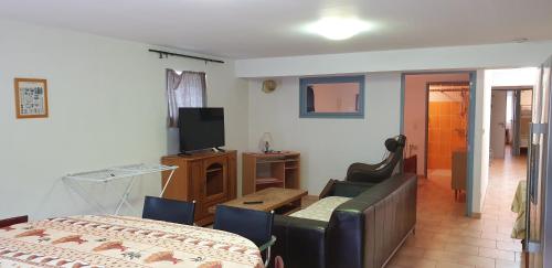 a living room with a couch and a television at Presqu'île de Chooz in Chooz