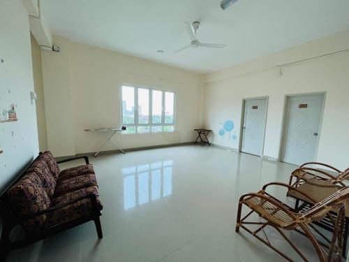 an empty room with a couch and chairs in it at Alexis KT Roomstay in Kuala Terengganu