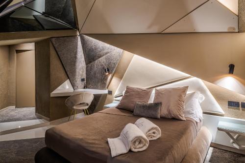 a bedroom with a large bed with towels on it at Le Suites Del Duomo Luxury in Catania