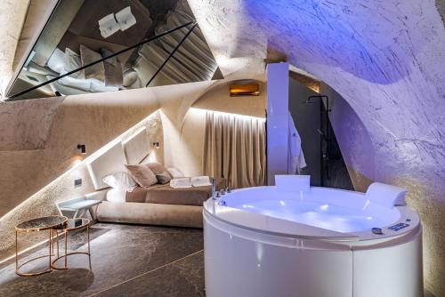 a bathroom with a tub in the middle of a room at Le Suites Del Duomo Luxury in Catania