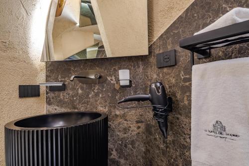 a bathroom with a sink and a mirror at Le Suites Del Duomo Luxury in Catania
