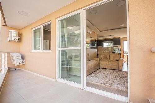 a living room with a sliding glass door at Apartamento a 200 metros da Praia do Cumbuco CE in Caucaia