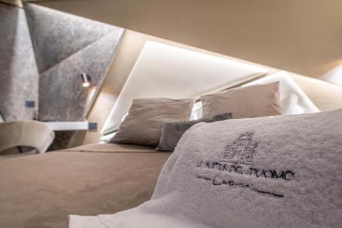 a bed with a pillow with the words im more than dad at Le Suites Del Duomo Luxury in Catania