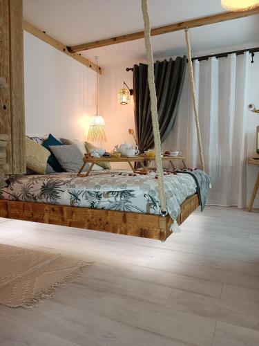a bedroom with a hanging bed in a room at Le Maréchal Duplex - Appartement avec Jacuzzi - CAEN hyper Centre in Caen