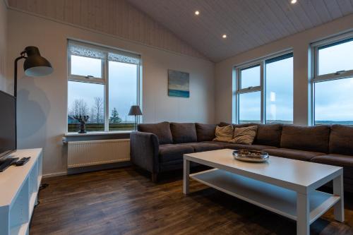 a living room with a couch and a table at Margrétarhof in Hella