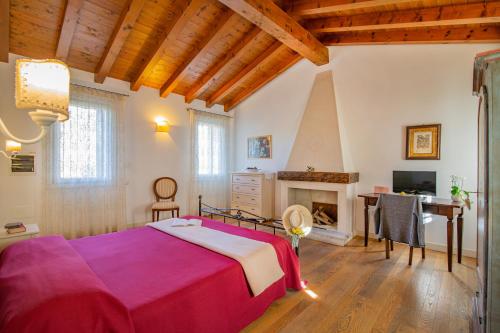 a bedroom with a bed and a fireplace at Ca' Dei Molini in Gruaro