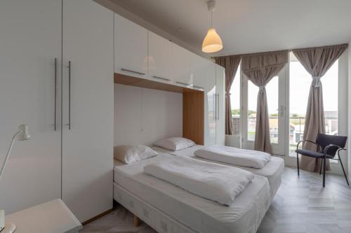 Postel nebo postele na pokoji v ubytování Strandleven appartement 201 - Groote Keeten