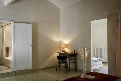 a bedroom with a table and a chair and a bed at Mas des Prêcheurs in Tarascon