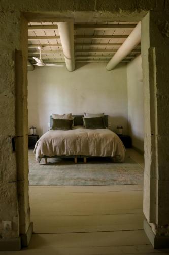 a bedroom with a large bed in a building at Mas des Prêcheurs in Tarascon