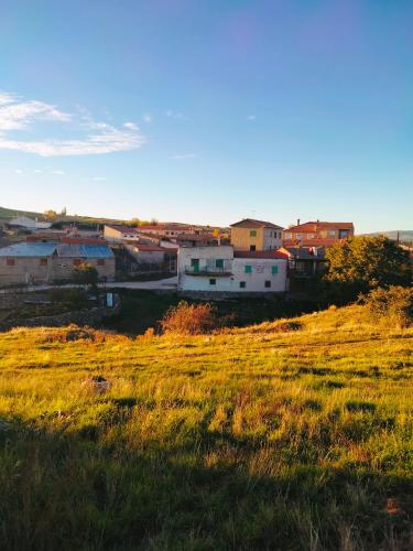 a group of houses on a hill in a field at El Robledillo in Robledillo