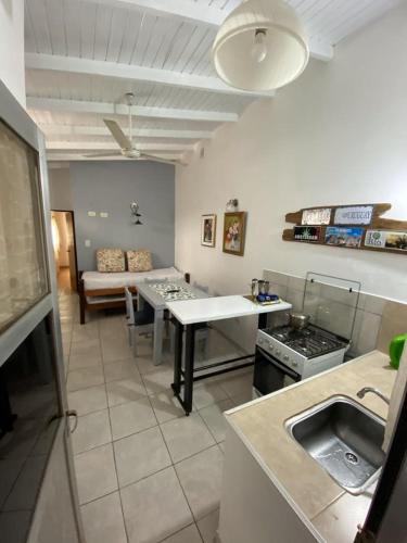 a kitchen and living room with a table and a couch at Espacio Calido in Posadas