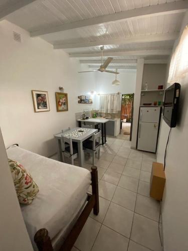 a room with a bed and a kitchen with a table at Espacio Calido in Posadas