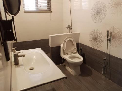 a bathroom with a toilet and a sink at HOTEL STATE RESIDENCY in Bahawalpur