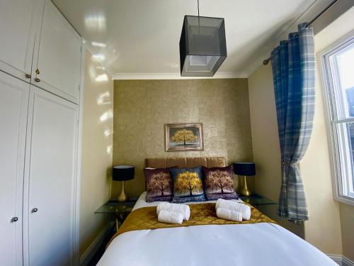 a bedroom with a large bed and a tv at Merewyke Boutique Luxury Family Apartment Sleeps 4 , Central Location in Windermere