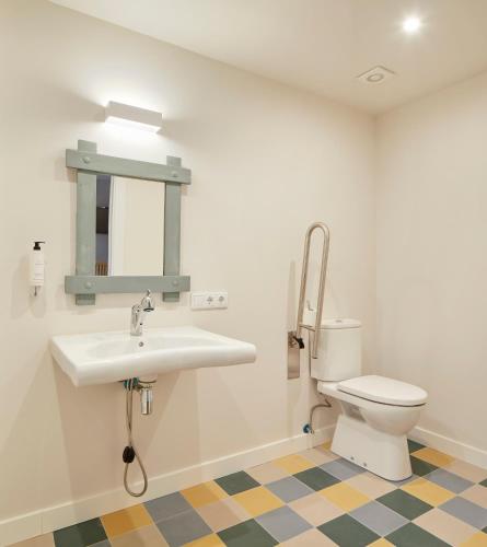 a bathroom with a sink and a toilet at Hostal Rural Aritzalko in Echarri-Aranaz