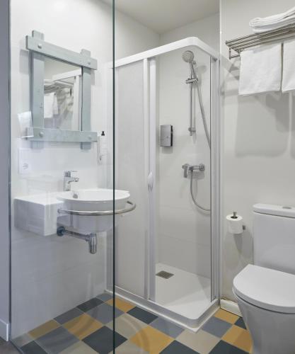 a bathroom with a shower and a sink and a toilet at Hostal Rural Aritzalko in Echarri-Aranaz