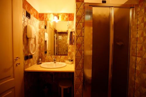 a bathroom with a sink and a mirror at Due Ponti Village in Cesenatico