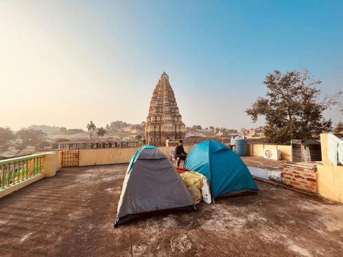 two tents sitting on the ground in front of a temple at TEMPLE VIEW GUEST HOUSE in Hampi