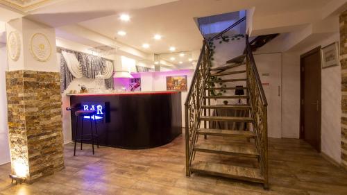 a spiral staircase in a room with a bar at Terrace Tbilisi Center in Tbilisi City