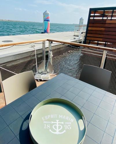 a table and chairs on the deck of a boat at Les Ilots de Gruissan in Gruissan