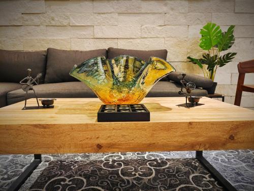 a large glass vase sitting on top of a coffee table at 1st Luxury Warehouse in Cancún