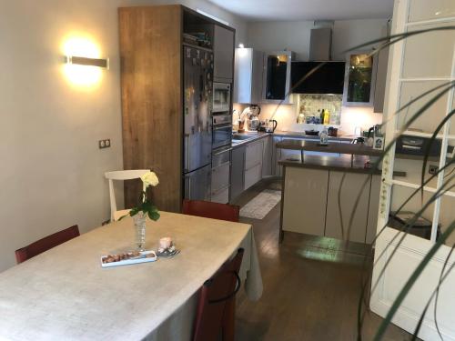 a kitchen with a table and a counter top at Villa Eugénie Melun in Melun