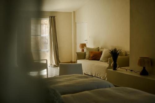 a living room with a bed and a window at Mas des Prêcheurs in Tarascon