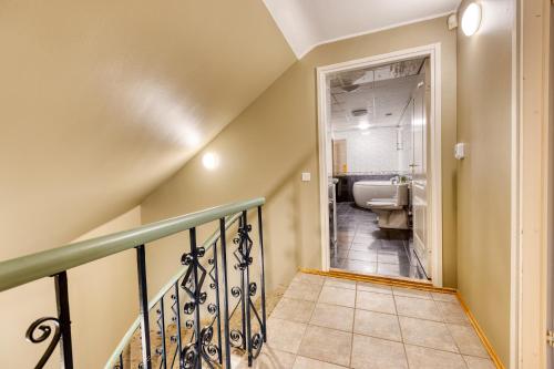 a staircase leading to a bathroom with a sink and a toilet at Historic Residence Apartments at Old Town in Tallinn