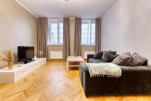 a living room with a couch and a tv at Historic Residence Apartments at Old Town in Tallinn