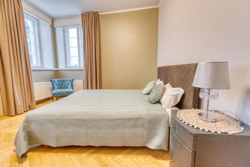 a bedroom with a bed and a table with a lamp at Historic Residence Apartments at Old Town in Tallinn