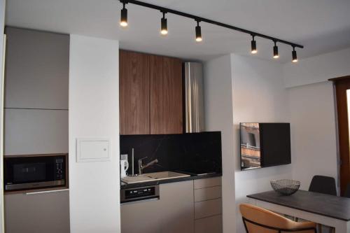 a kitchen with a sink and a counter top at La Perle Montana in Crans-Montana