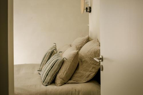 a pile of pillows on a couch in a room at Mas des Prêcheurs in Tarascon