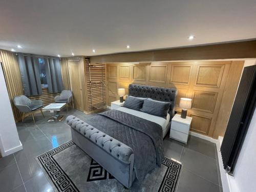 a bedroom with a bed in a room with wooden cabinets at Hendham House in Manchester