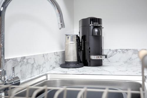 a coffee maker sitting on a counter next to a sink at Luxury Duplex 2-Bed Apartment Fruit Market Marina in Hull