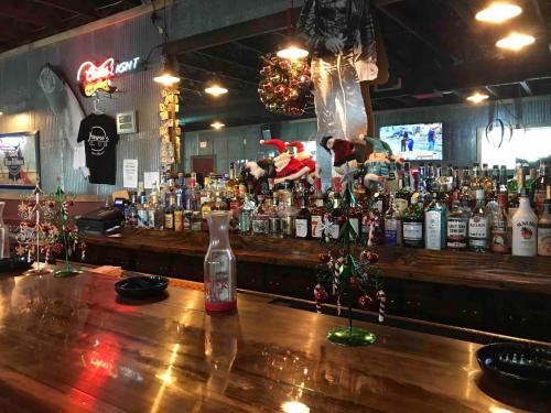 a bar filled with lots of bottles of alcohol at Walnut Inn - Checotah in Checotah
