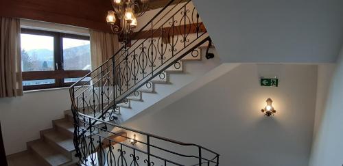 a staircase in a house with a chandelier at Gästehaus Huber in Mittersill