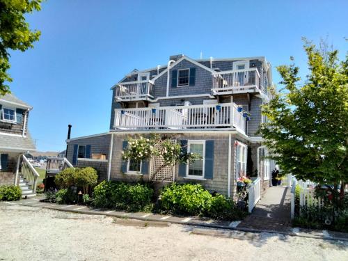 a large house with a balcony on the side of it at An English Garden in Dennis Port