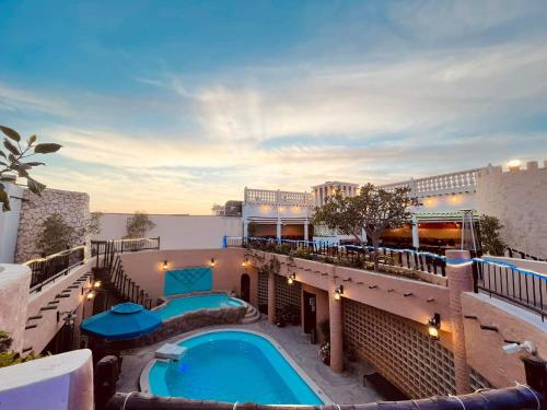 a swimming pool on top of a building at Al Liwan Suites in Doha