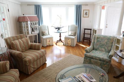 a living room with chairs and a table at An English Garden in Dennis Port