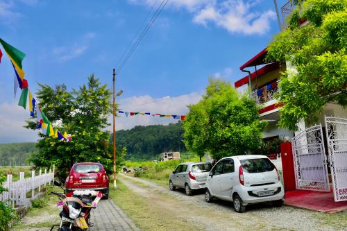 a group of cars parked next to a building at River Stay - Homestay by Wanderlust Rural Tourism in Dehradun