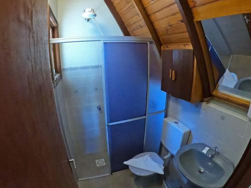a small bathroom with a shower and a toilet at Pousada Verde Agua in São Lourenço do Sul